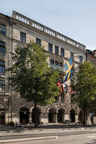 Exterior of the hotel with many flags at The Sparrow Hotel