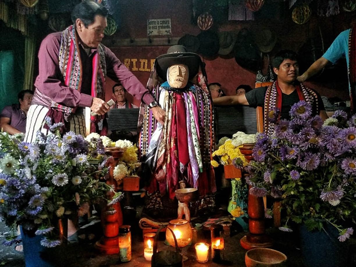 People trying scarfs & hats on mannequins in Santiago Atitlan near Regis Hotel & Spa