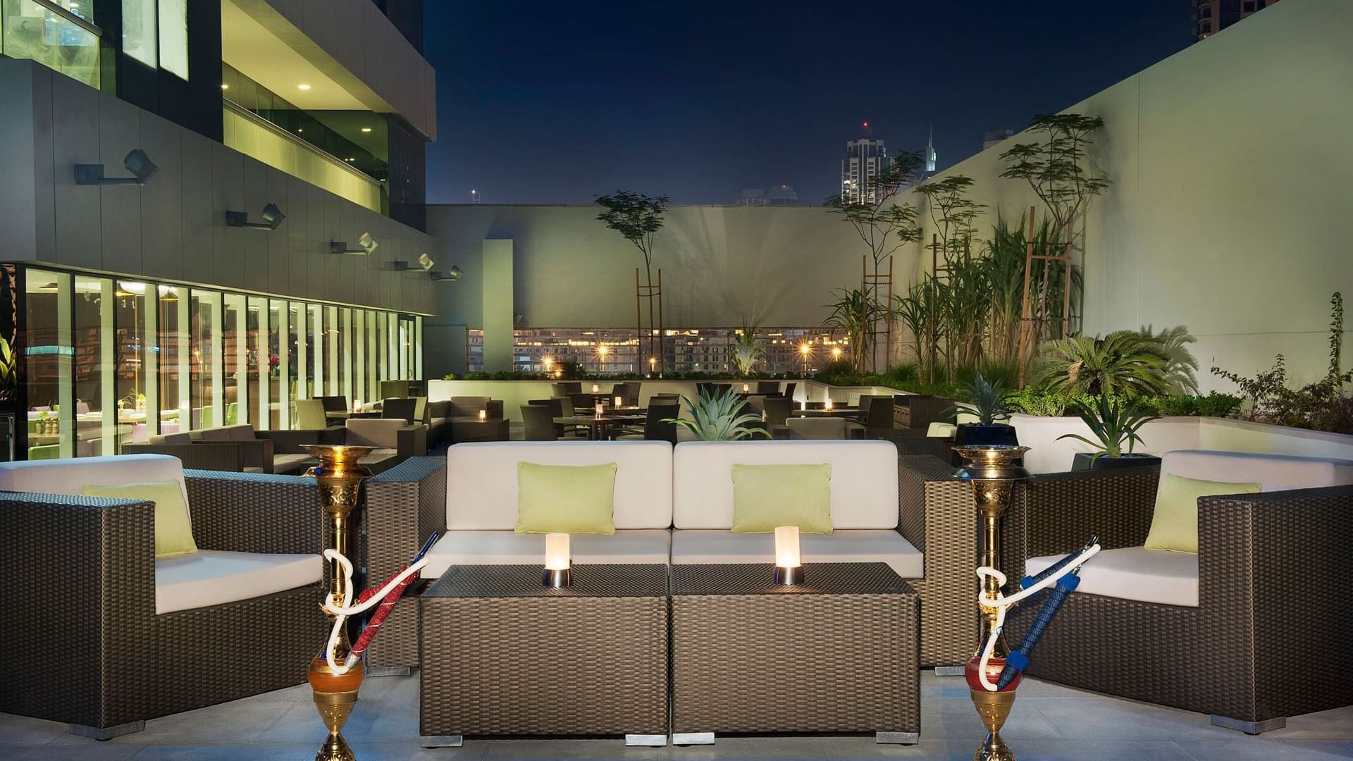 Outdoor dining area arranged with shisha in La Maison Restaurant at DAMAC Maison Canal Views