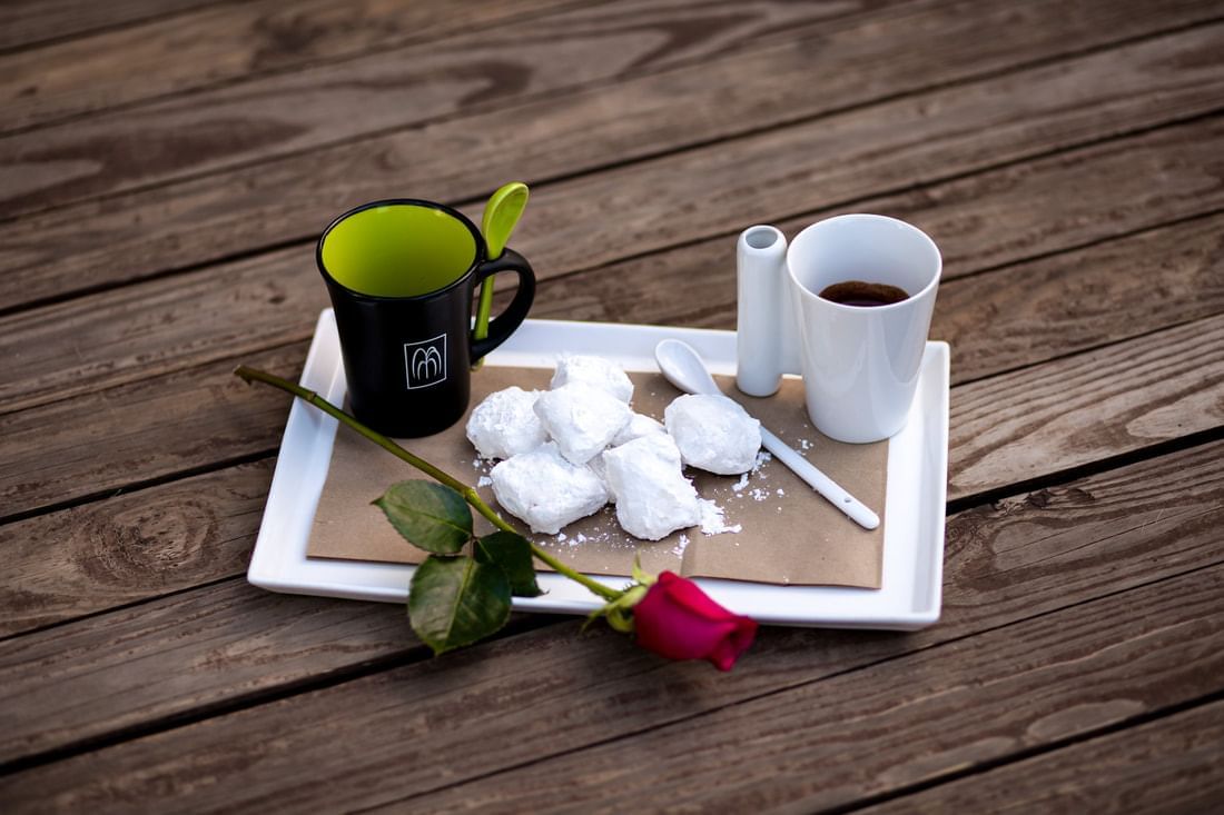 Close-up of two mugs, sugar cubes and a rose on a tray at the Inn at Willow Grove 