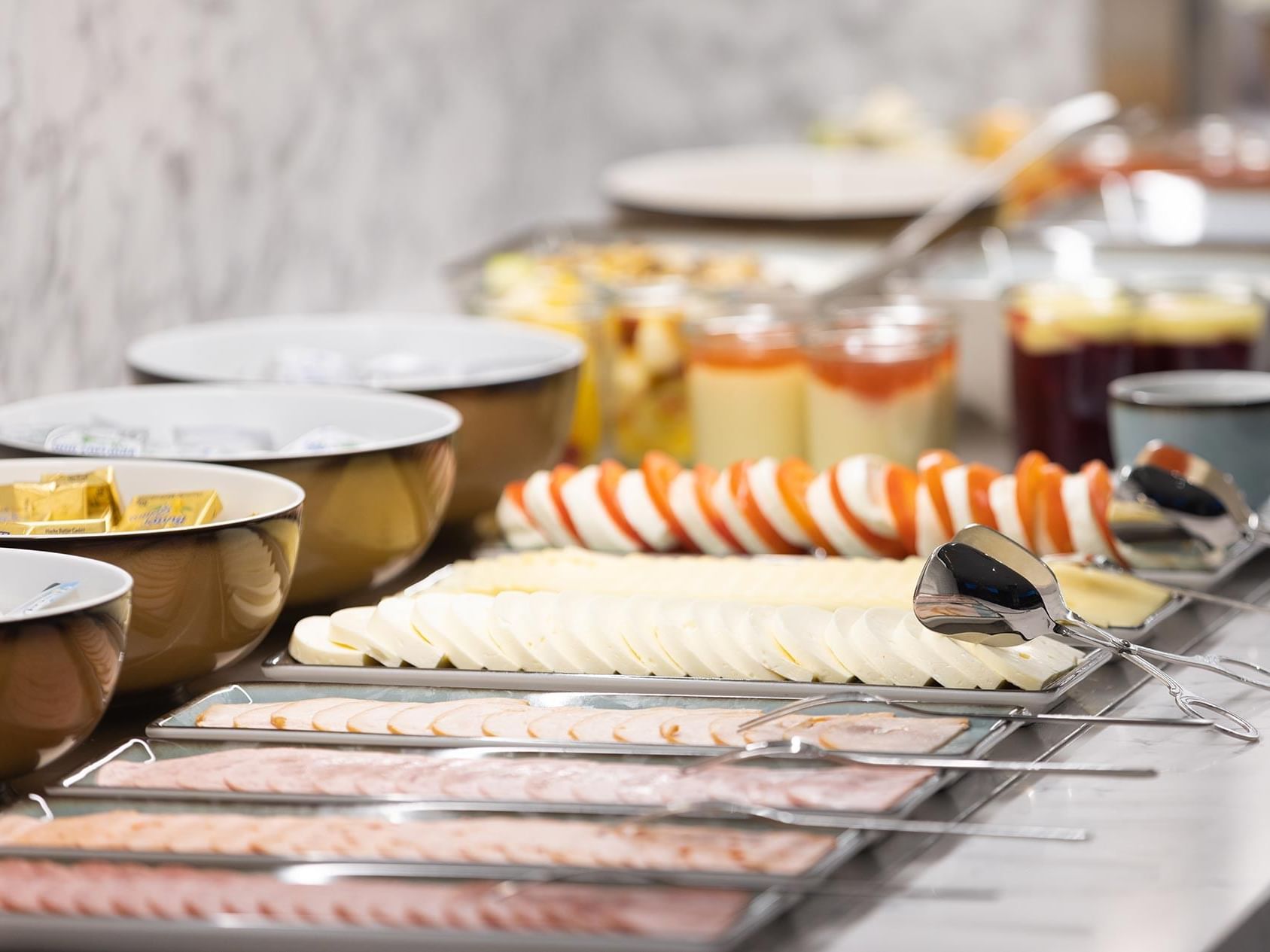 Buffet Breakfast with sliced toppings and other dishes in Breakfast Restaurant at Titanic Comfort Kurfürstendamm