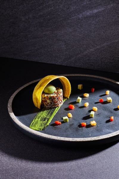 A neatly arranged appetizer on a plate at Hotel Sumaq