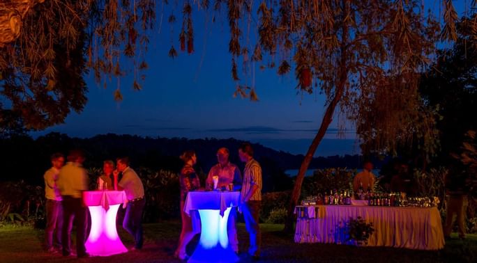 People having sundowners by the lake at Arusha Serena Hotels