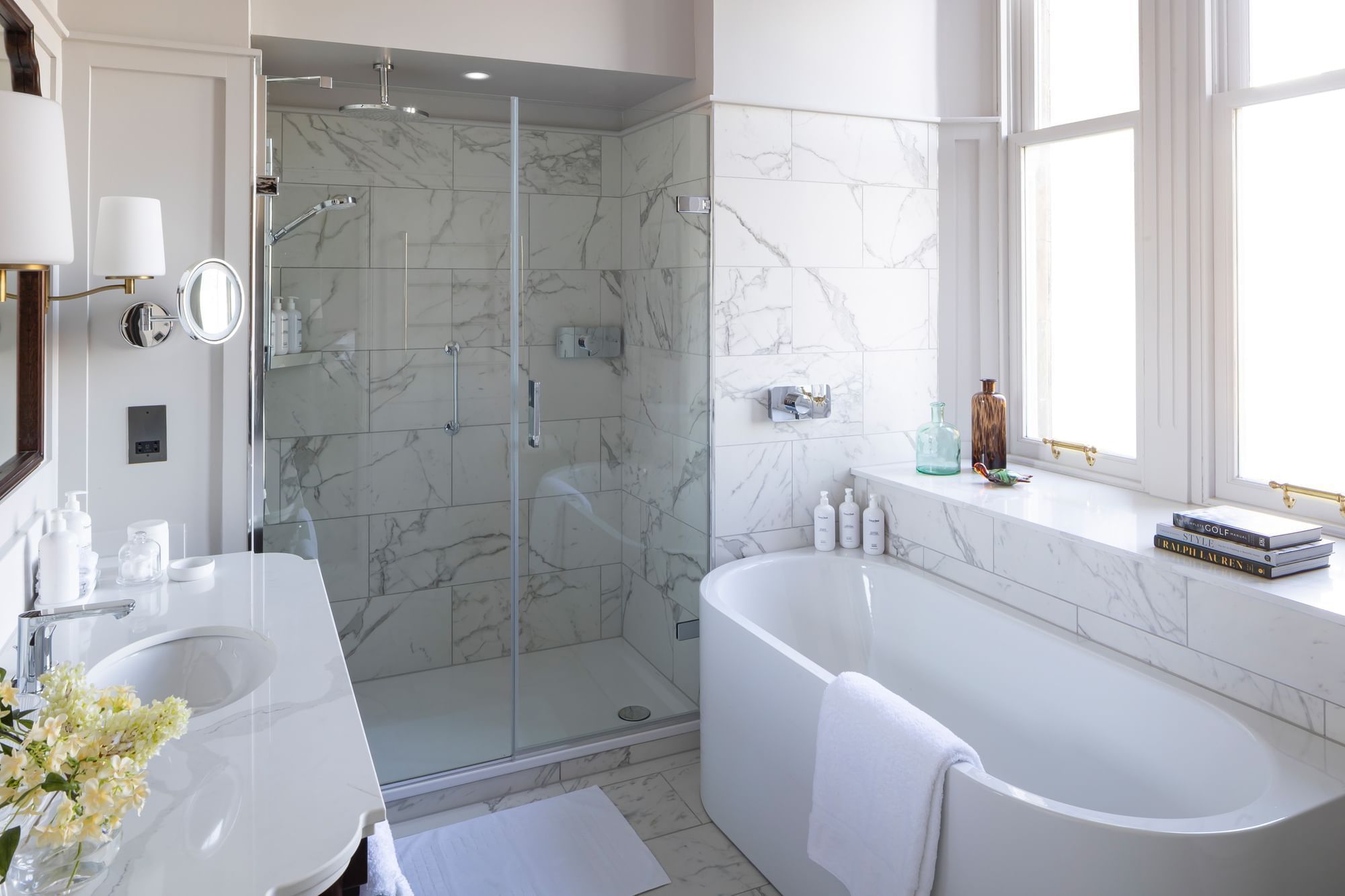 Junior Suite with Sea View bathroom, featuring a white vanity, a glass shower, and a large soaking tub at Seaton House