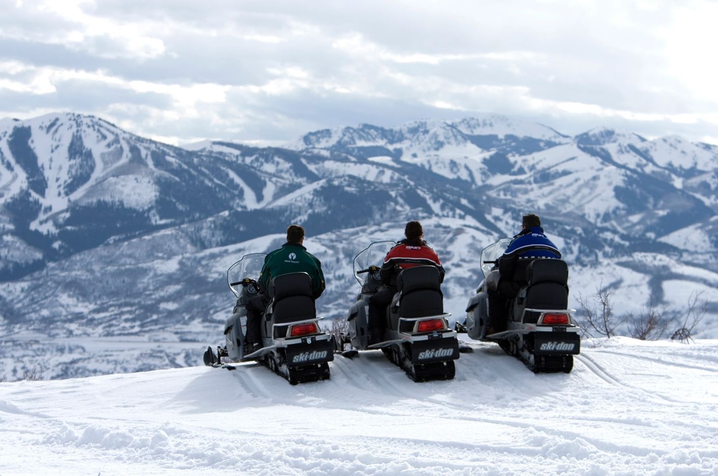 Three people snowmobiling near our Deer Valley Park City Utah Hotel