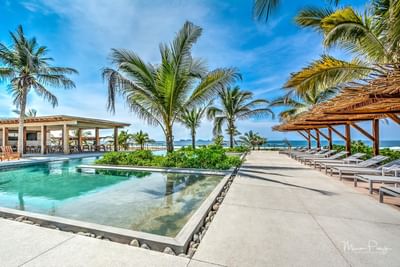 Sunbeds by the pool with a sea view, Marea Beachfront Villas