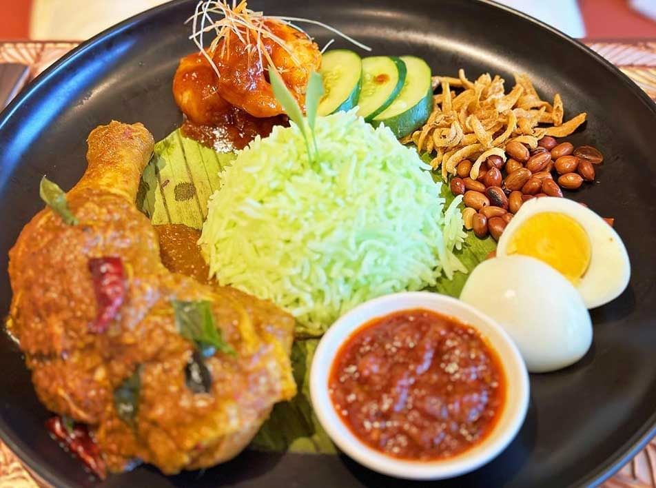 Nasi lemak dish served on a street food stall table near Imperial Lexis Kuala Lumpur