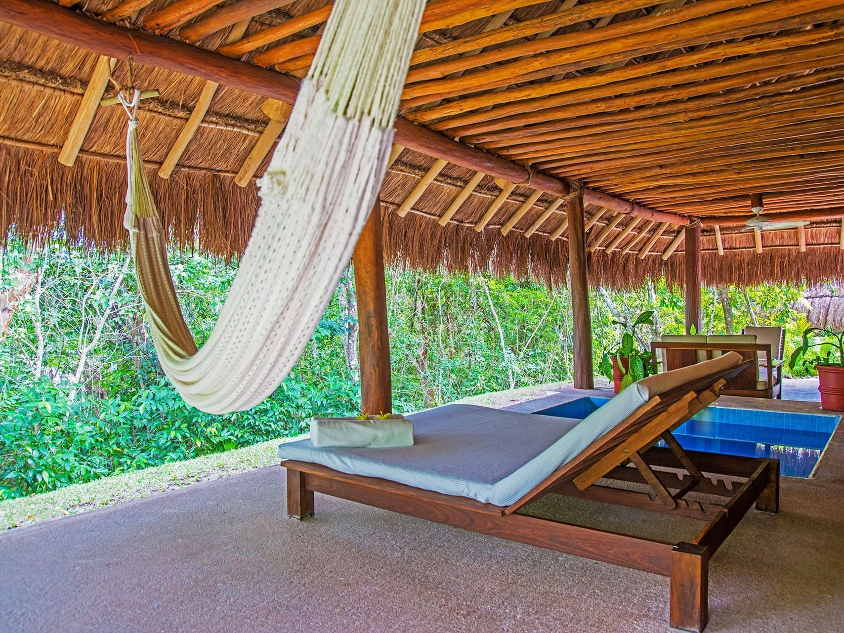 Cabana terrace with a hammock at  La Colección Resorts