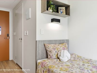 Clean room with bed and floral bedding at Mayoral Drive Student Accommodation.