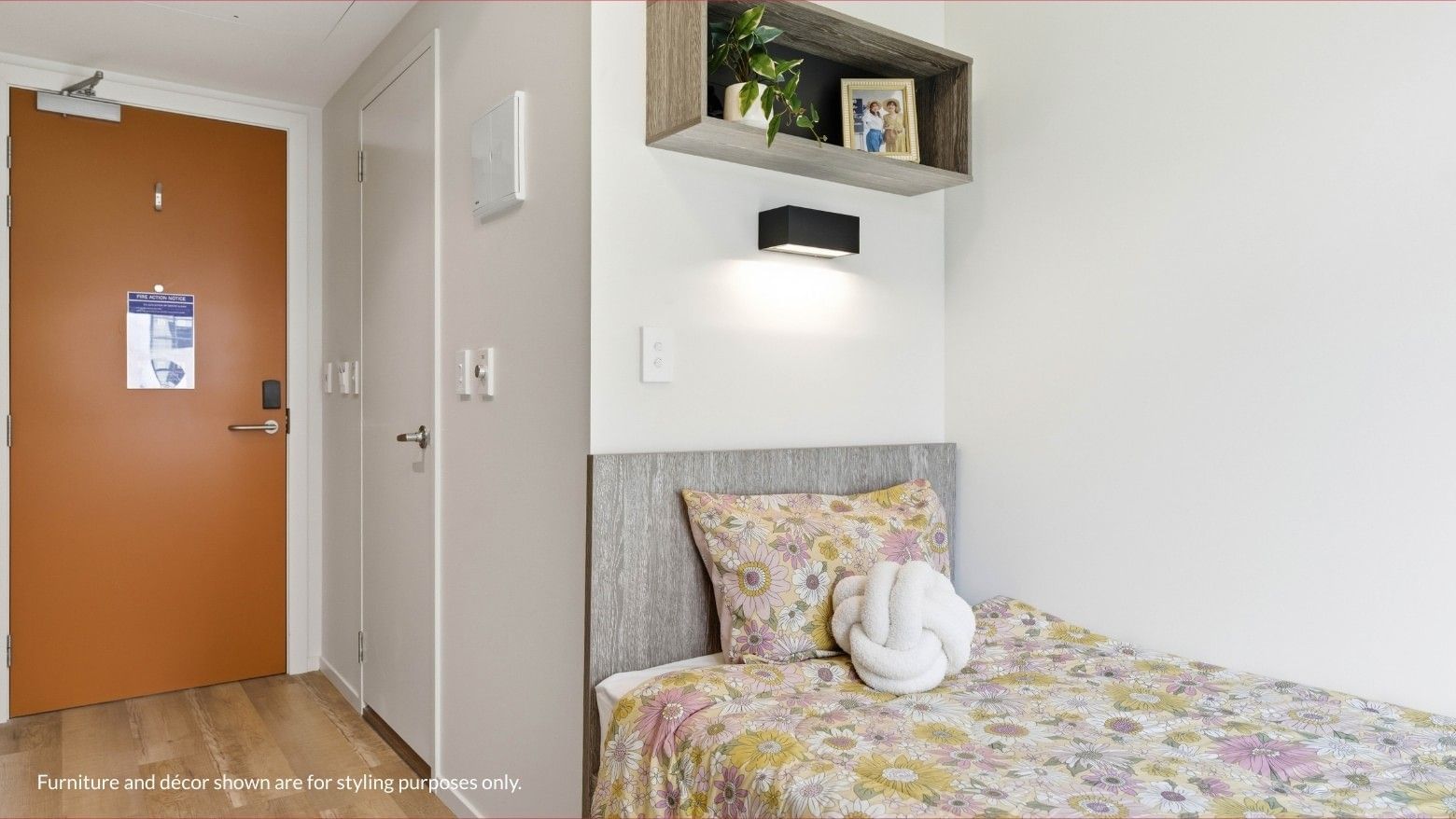 Student room with bed, nightstand, and shelf at Mayoral Drive Student Accommodation.