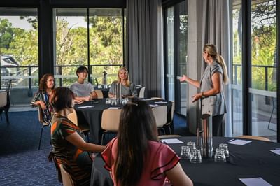 Lady hosting a meeting in a Meeting Room at Nesuto Curtin Perth