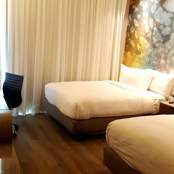 Twin beds with working desk in Superior Room at Fiesta Inn