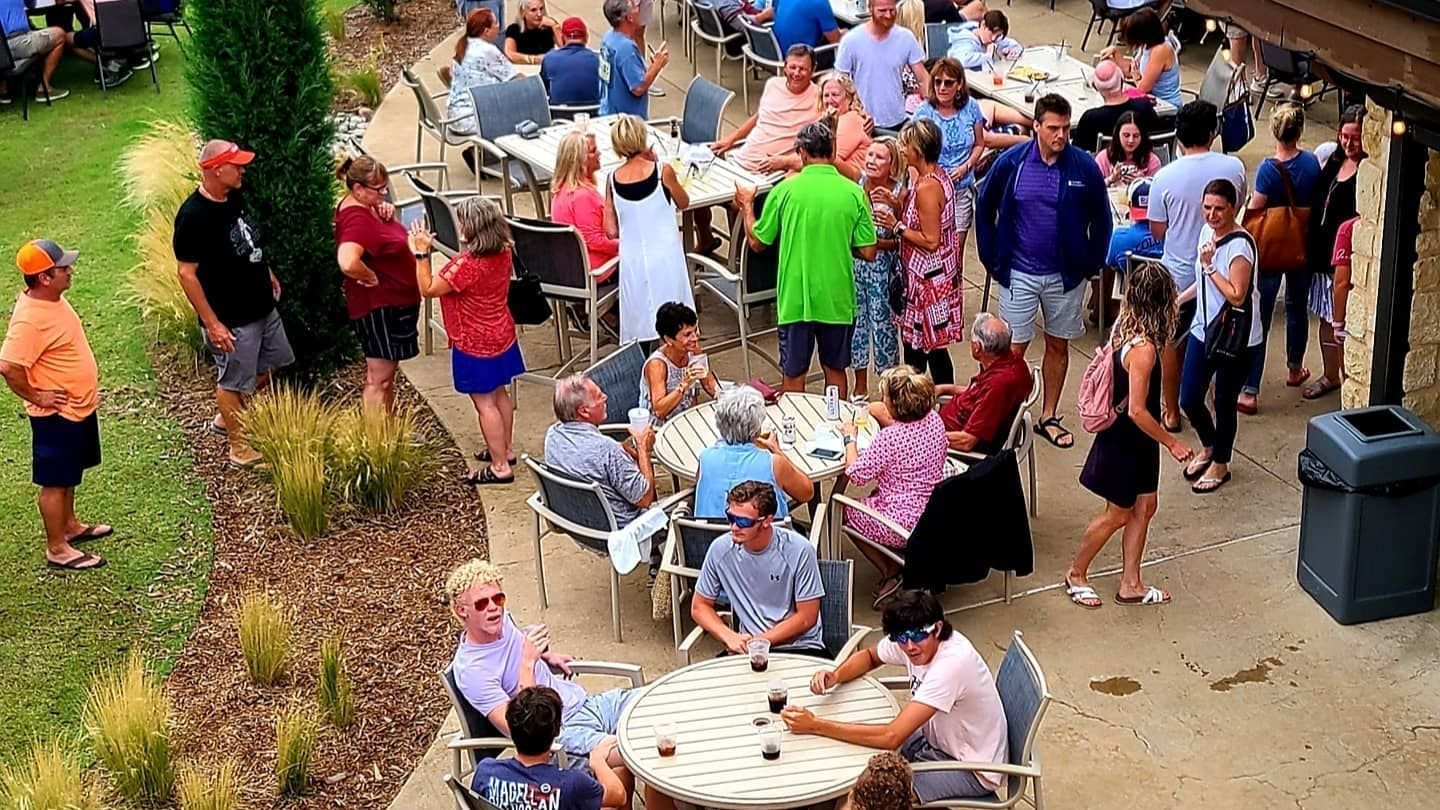 Lively outdoor gathering with numerous people socializing in Doc's lower Patio at Shangri-La Monkey Island