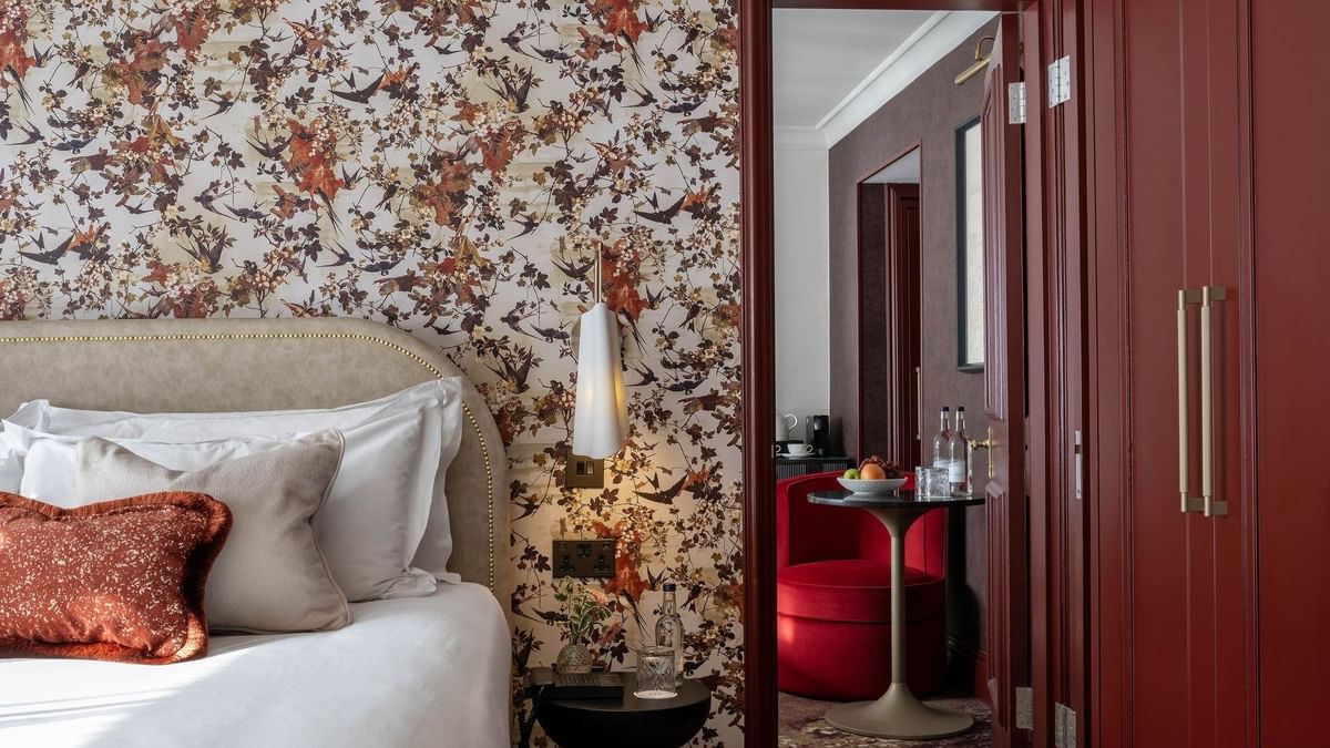 Close-up of bed with side table and mirror in Superior King at The Capital Hotel, Apartments and Townhouse