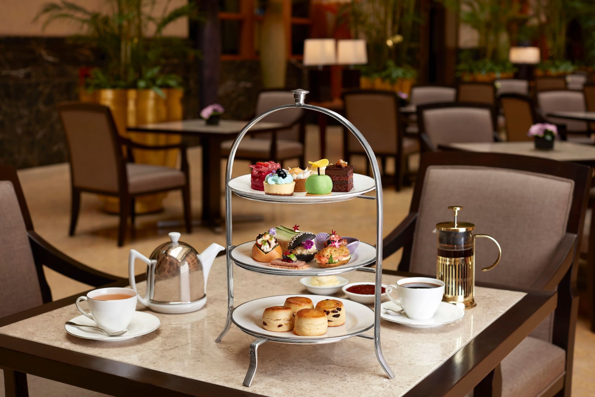 High tea platter with desserts and beverages served in The Courtyard at The Fullerton Hotel Singapore
