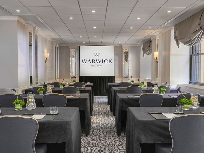 Classroom table set-up facing large screen in Sussex Meeting Room at Warwick New York