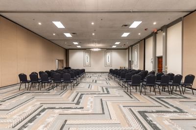 Theatre chairs with carpeted floors in McKinley Room at M Hotel Buffalo