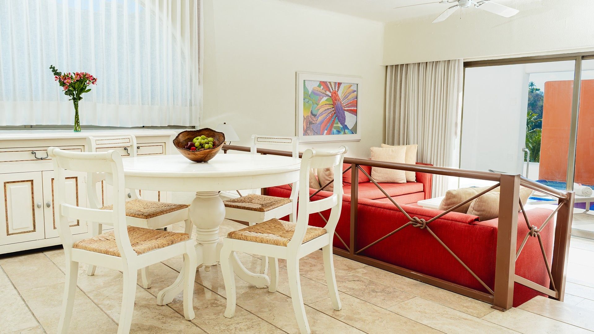 Dining table by cozy lounge area with wooden floors in King Suite Private Pool at Camino Real Zaashila Huatulco