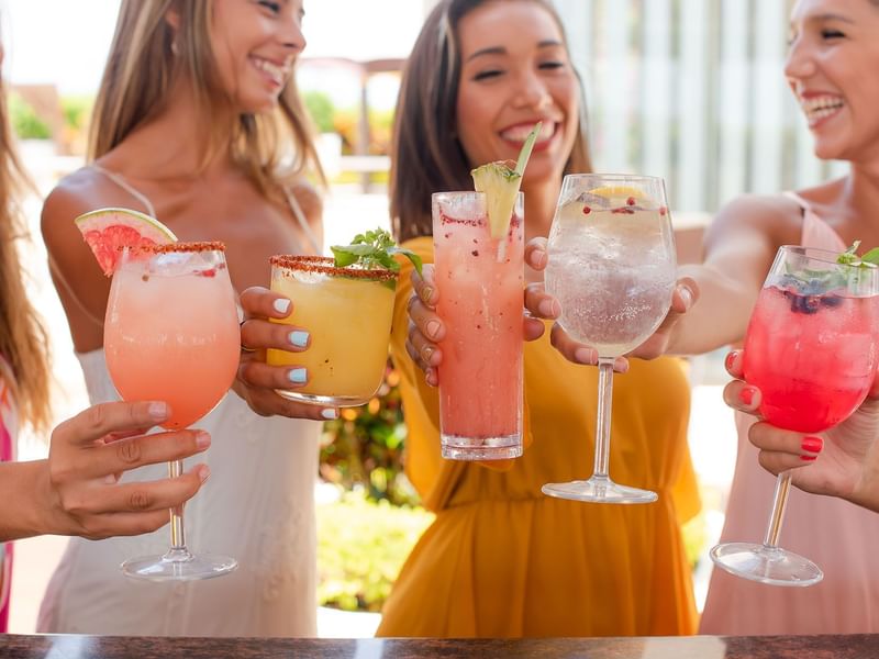Amigas disfrutando bebidas premium en la terraza de The Reef 28