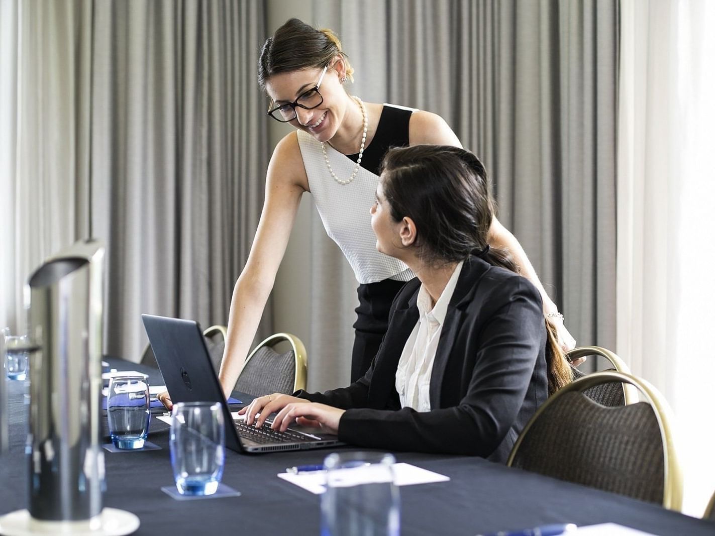 Two ladies discussing in the meeting room at the Sebel Residence Chatswood