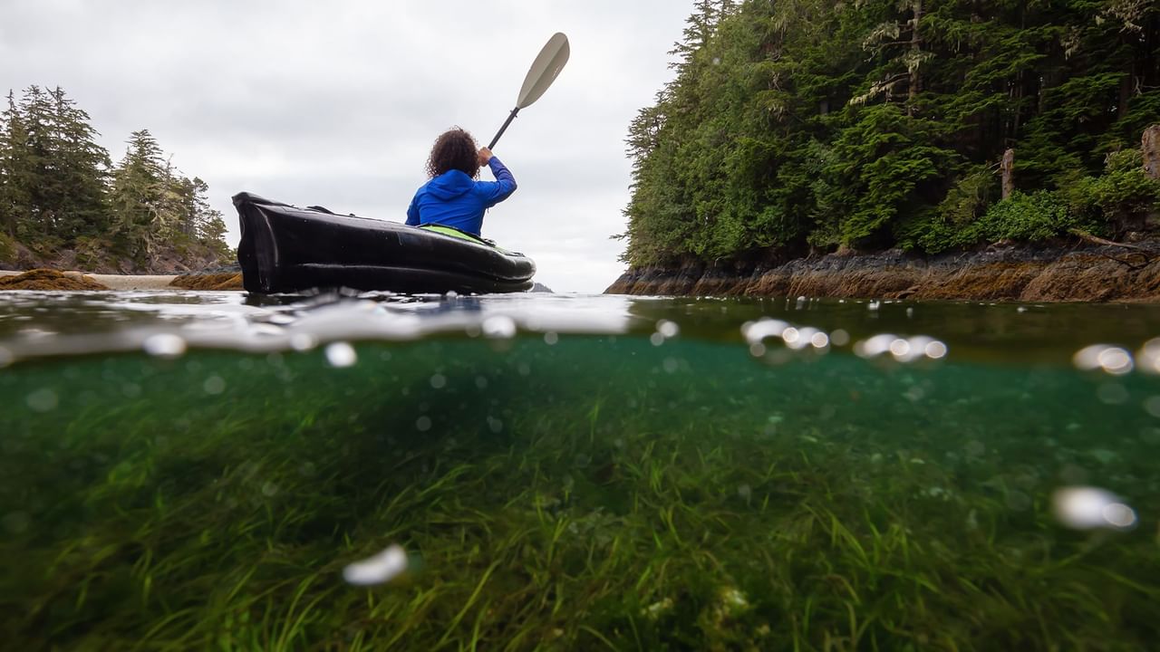 over and under water with a woman kayaking