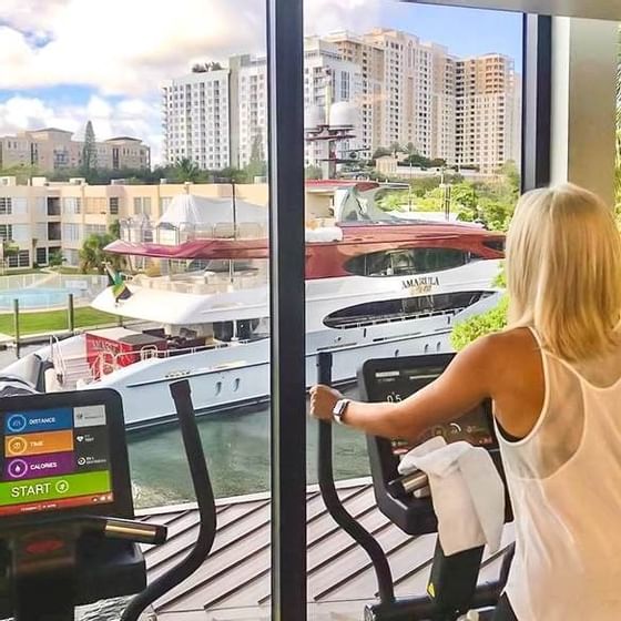 woman on fitness equipment overlooking river