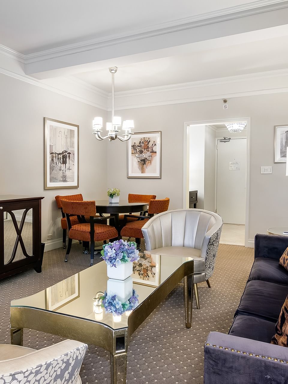 Premier Suite TV lounge with plush seating and a dining table at Warwick New York