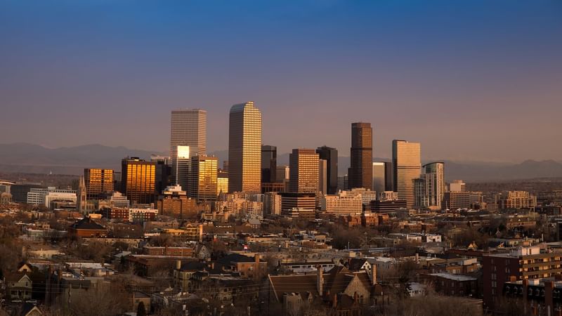 Sunset view of Denver's skyline, featuring gleaming skyscrapers and locations near Warwick Hotels and Resorts