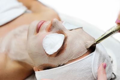 A woman getting a facial at Peabody Hotels & Resorts