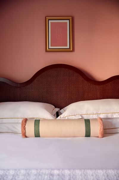 Wall art by a comfy bed with pillows at Esme Miami Beach