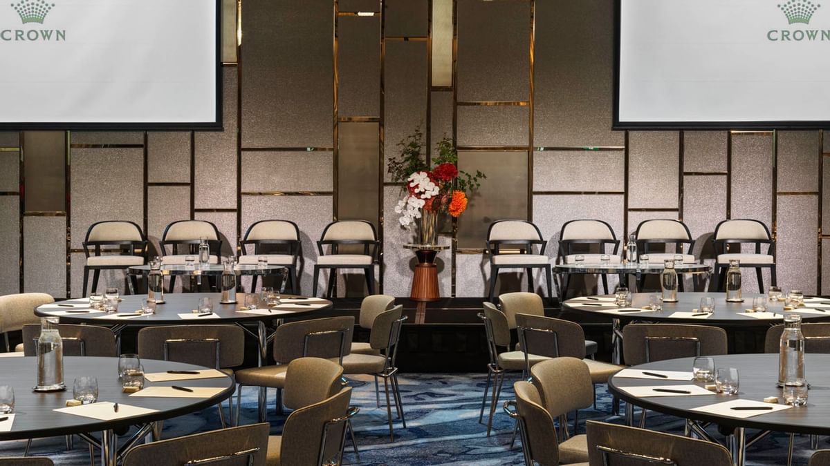 Pearl Ballroom with project screen and tables set for an event at Crown Towers Sydney