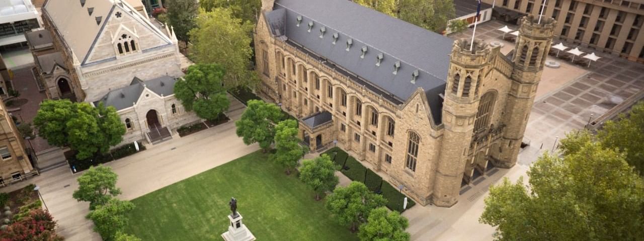 Aerial view of the University of Adelaide's North Terrace campus, featuring green lawns near Ibis Adelaide