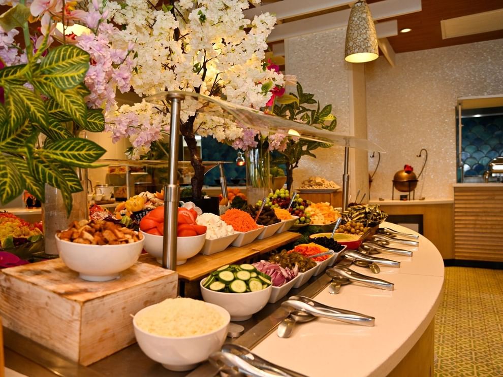 Flower-adorned buffet spread with various food dishes at Warwick Paradise Island - Bahamas, Nassau.