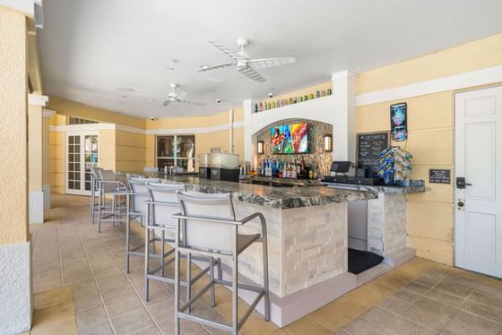 Bar area with stools and a counter at Vista Cay Resort By Millenium