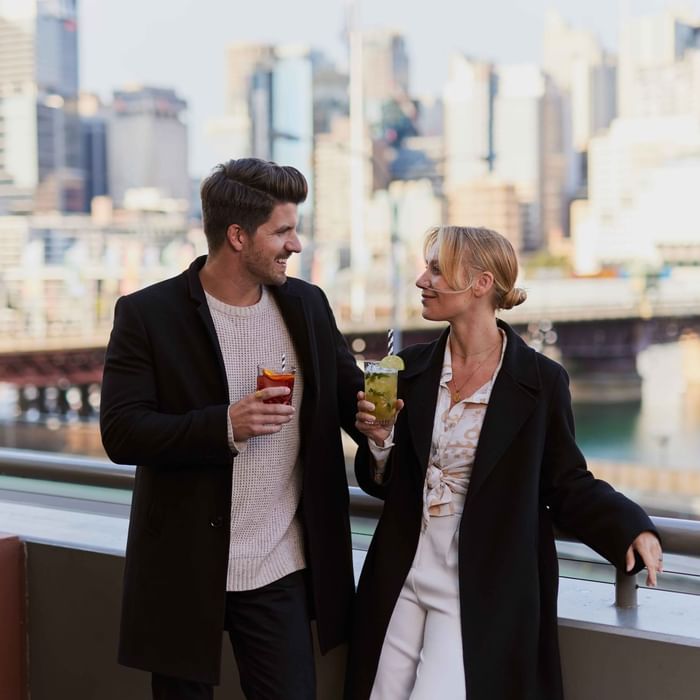 Couple enjoying sunset drinks on ibis bar deck