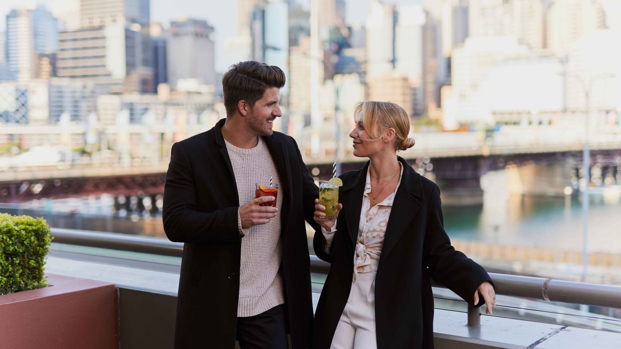 Couple enjoying sunset drinks on ibis bar deck