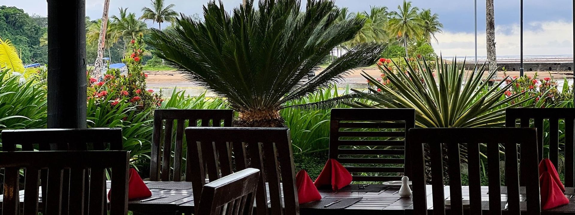 Chairs and tables with red napkins in Nukunuku Restaurant & Bar at The Naviti Resort Korolevu