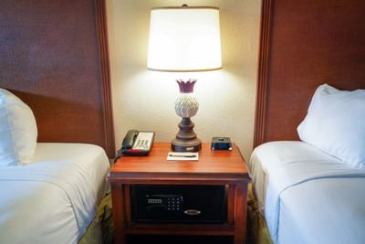 A desk featuring a lamp, phone, and notepad in a room at Rosen Inn Lake Buena Vista