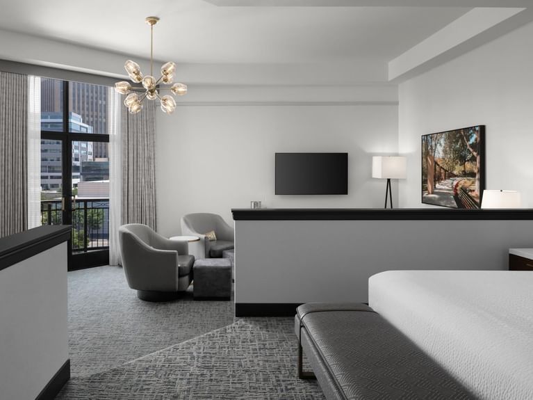 Longitude Suite with a luxurious living area, city views, and a stylish chandelier at Hotel 43 Boise