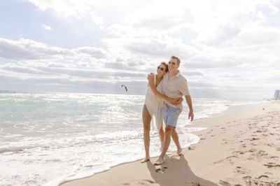 Couple walking down the beach at Diplomat Resort in Hollywood Florida