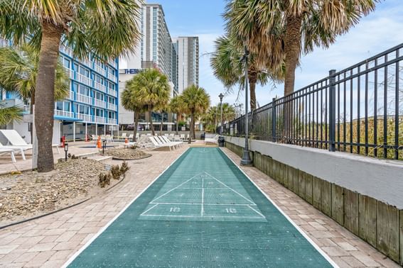 A tennis court set up on sidewalk near The Yachtsman Resort