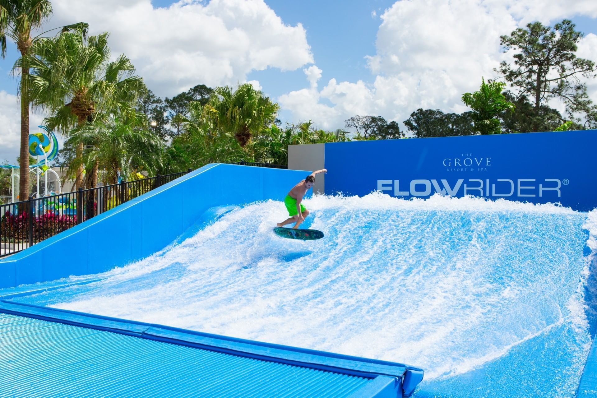 Flow rider skillfully rides a wave on a surfboard at Surfari Water Park Resort