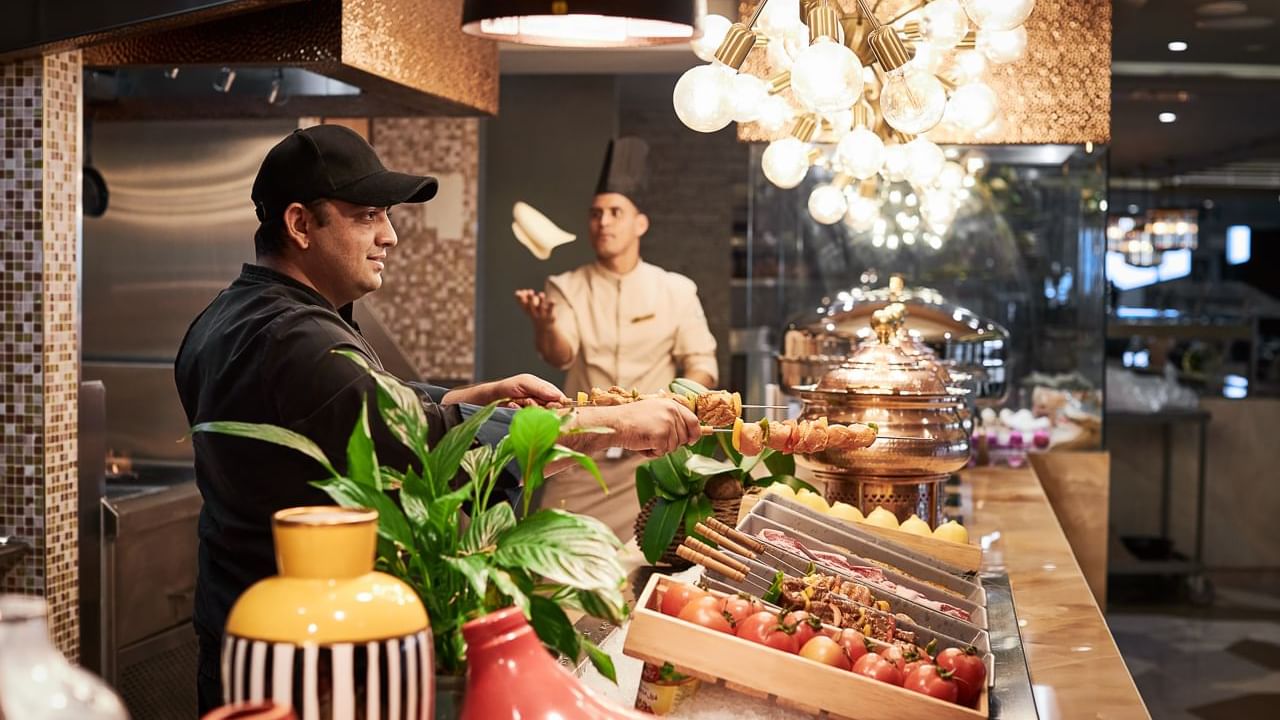 Chef serving food at the buffet area in The Stage Restaurant at Paramount Hotel Dubai