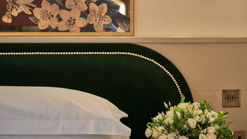 Bouquet of white flowers by the king bed in Deluxe at The Capital Hotel London