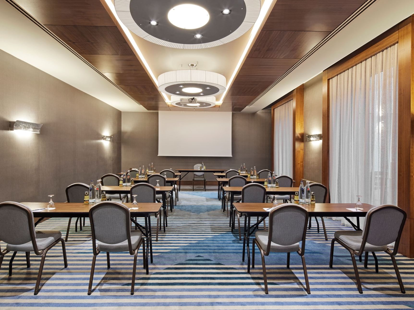 Klassenzimmerbestuhlung mit digitalem Bildschirm in einem Tagungsraum im Titanic Chaussee Berlin.