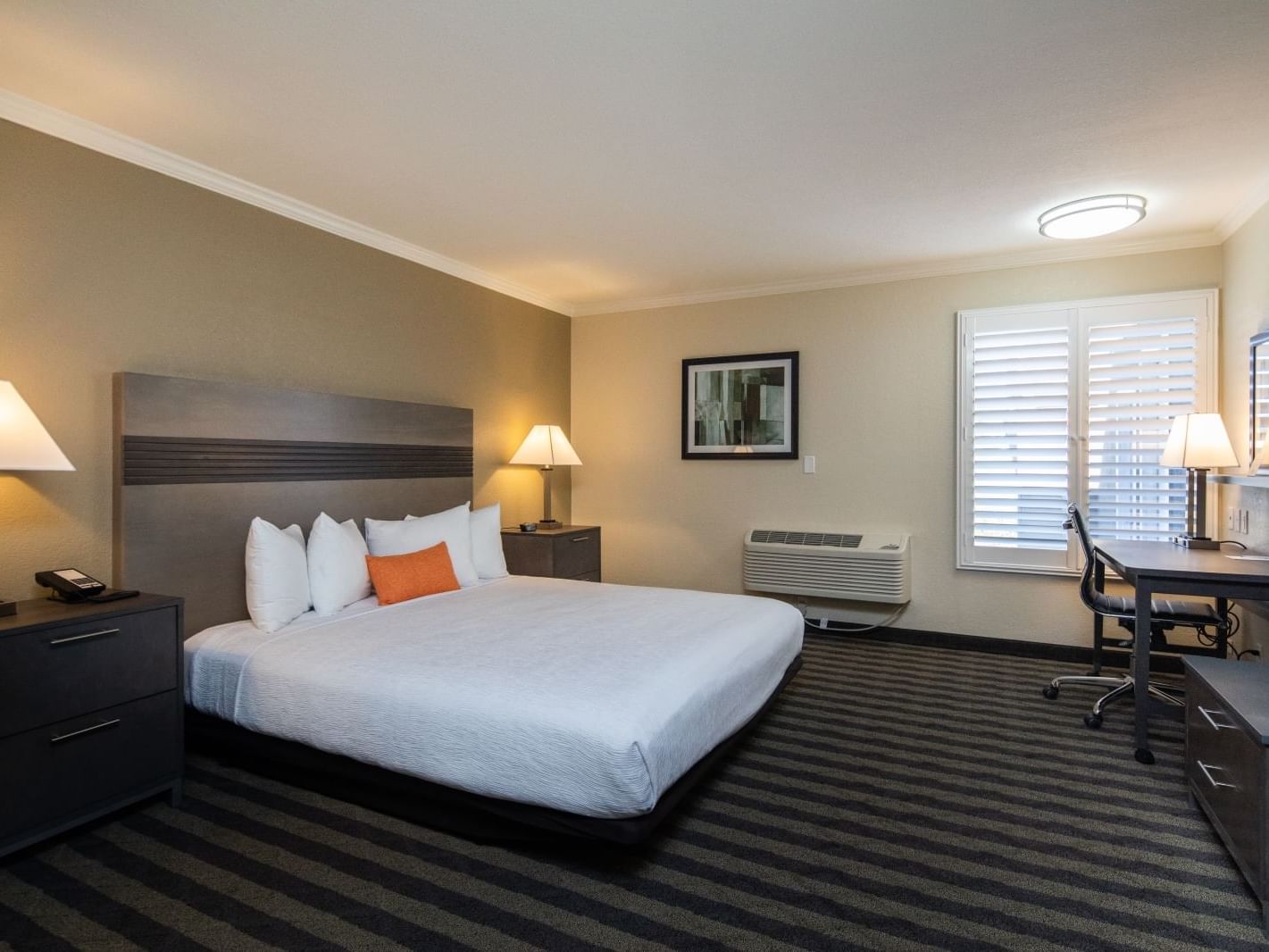 large bed and a desk in a hotel room