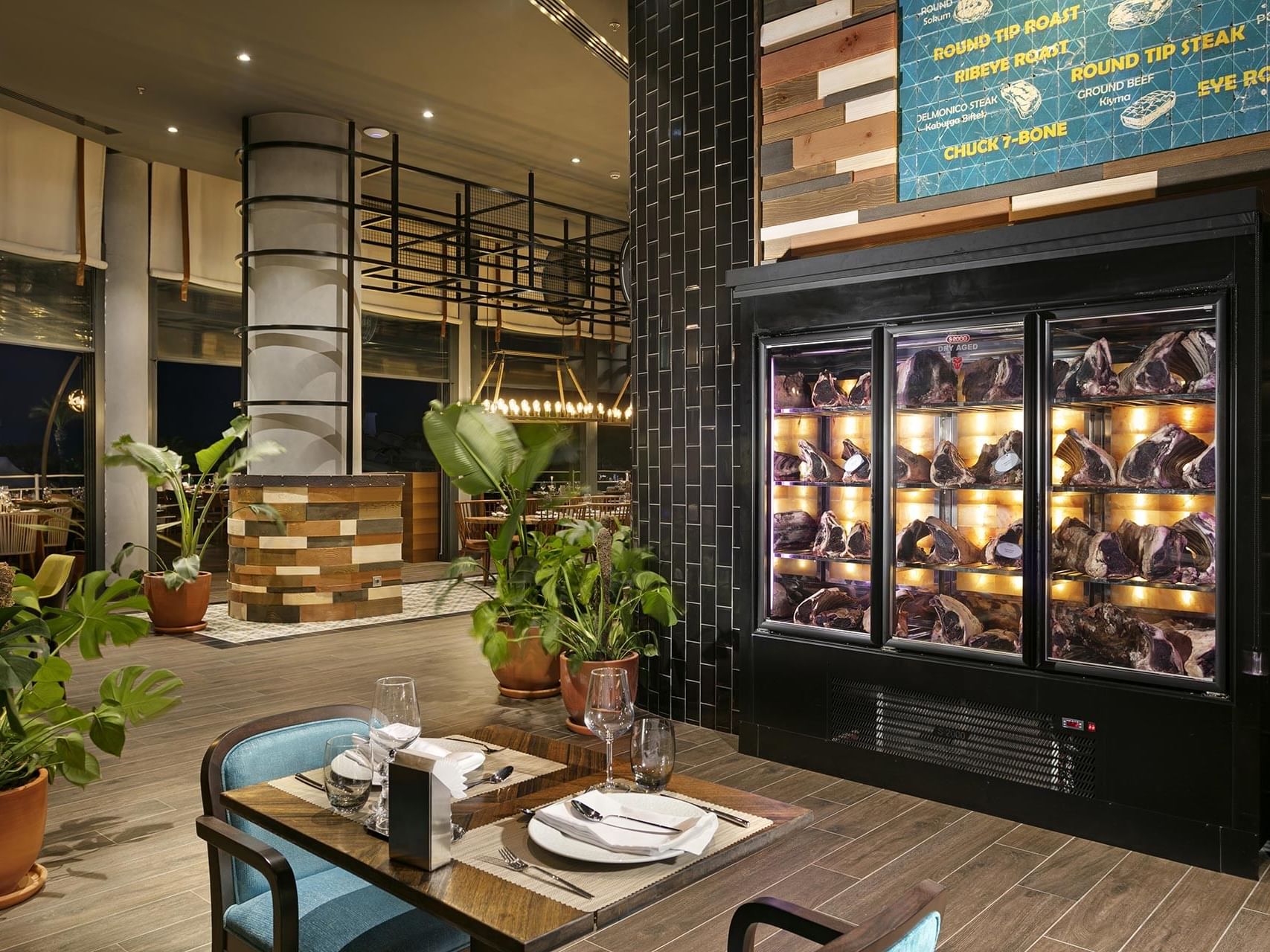 Interior of dining lobby with table and chairs in Beef Grill Club at Titanic Deluxe Lara