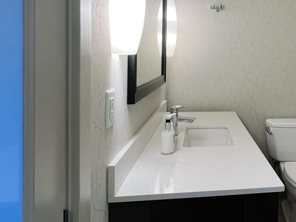 Bathroom with toilet, mirror, sink