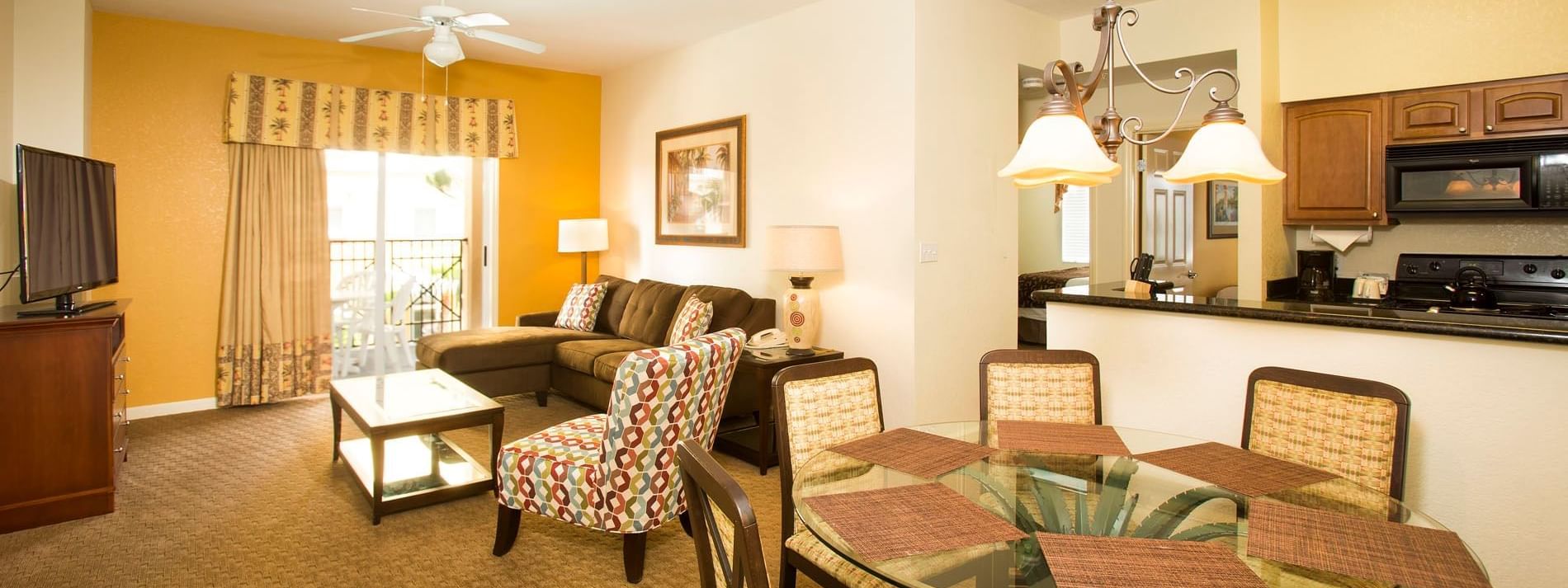 A wide view of a suite's living area, kitchen, and dining space.