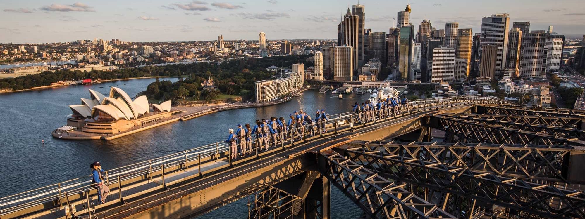 People climbing the Sydney Harbour Bridge with Opera House view, near Novotel Sydney on Darling Harbour
